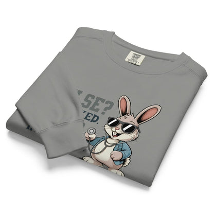 Folded gray sweatshirt with cartoon rabbit design and text on a white background