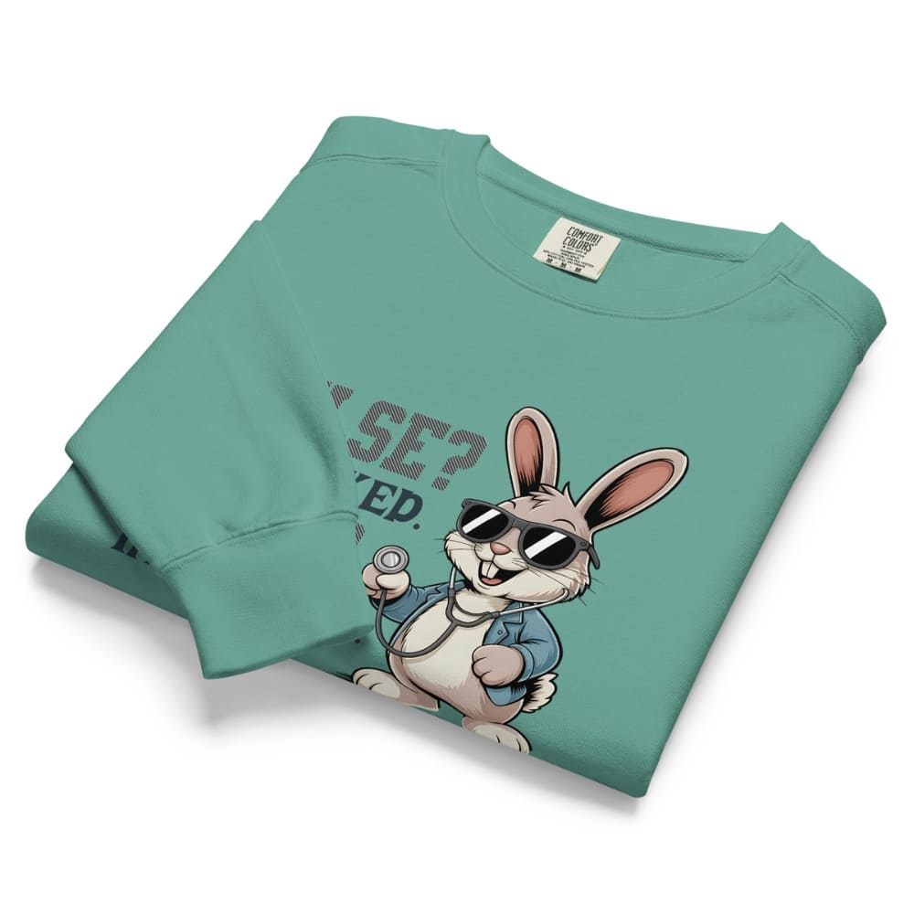 Folded teal sweatshirt with cartoon rabbit design and text on a white background