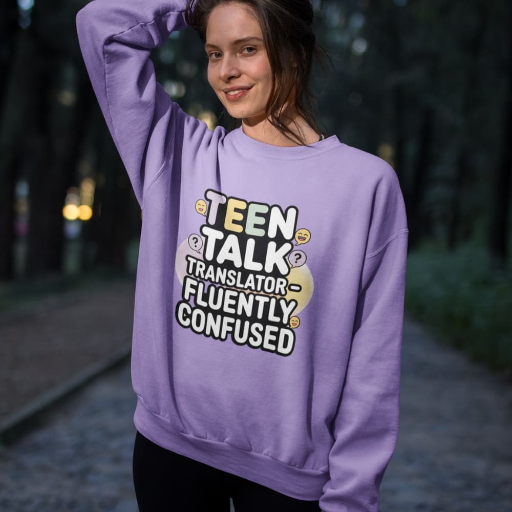 Person wearing a purple sweatshirt with text in an outdoor setting