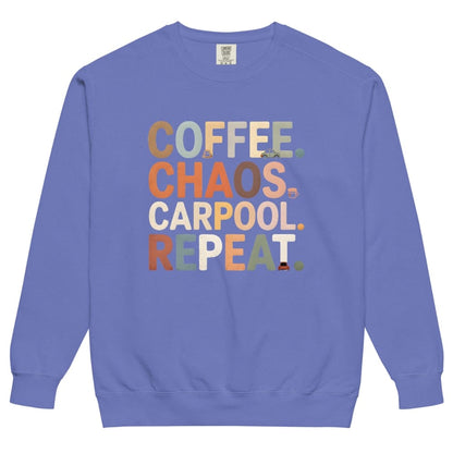 Blue sweatshirt with colorful text 'COFFEE. CHAOS. CARPOOL. REPEAT.' on a white background