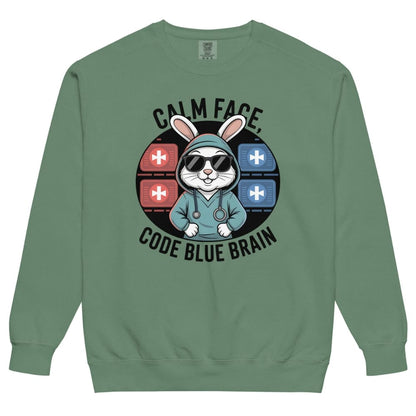 Green sweatshirt with a graphic design of a rabbit in a medical outfit and text 'Calm Face, Code Blue Brain' on a white background.