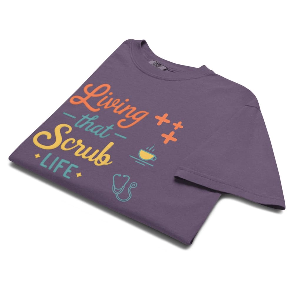 “Living That Scrub Life” colorful text printed on a garment-dyed cotton t-shirt for nurses and healthcare professionals