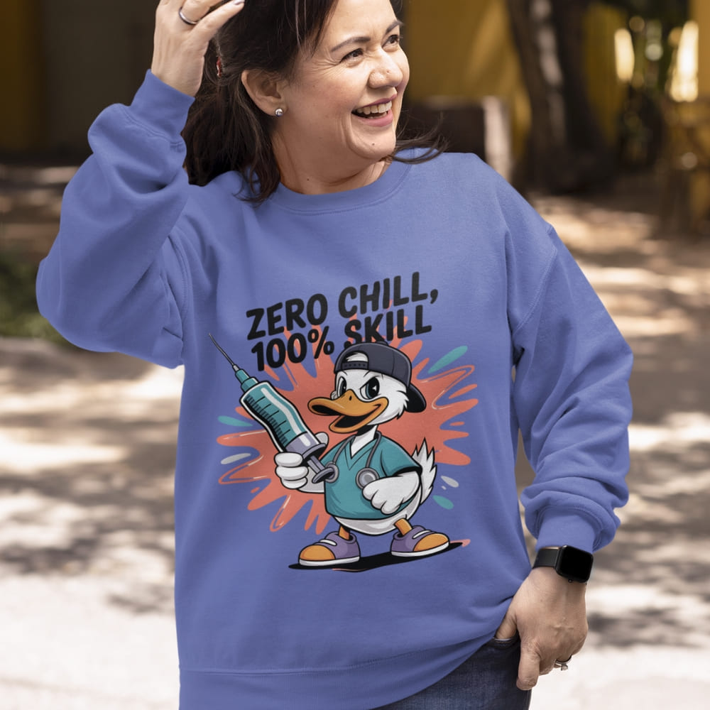 Person wearing a blue sweatshirt with a cartoon duck design and text outdoors.