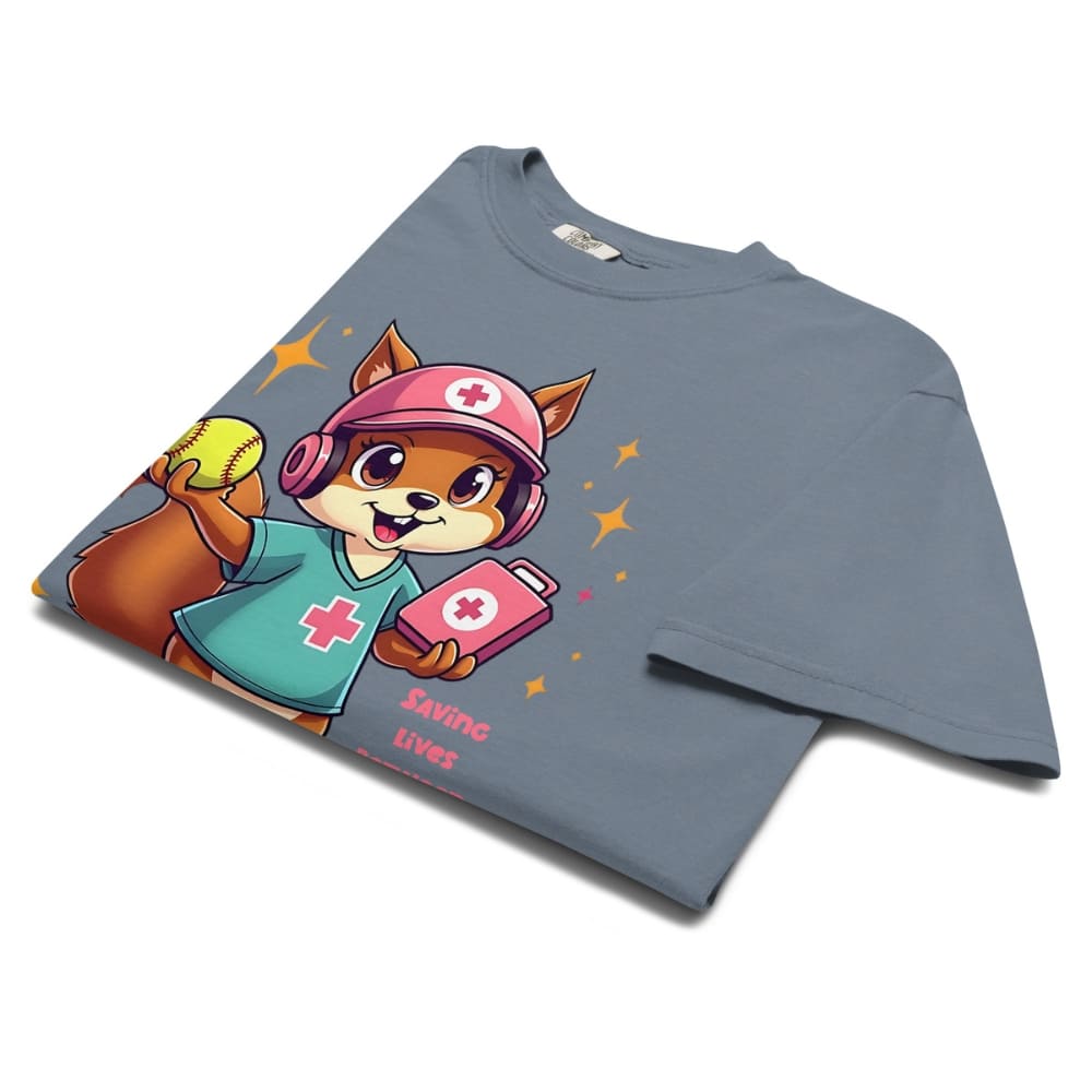 Cute squirrel nurse cartoon in scrubs, pink cap, and headset holding a softball and medical kit with the phrase “Saving Lives Between Innings” — printed on a heavyweight cotton t-shirt