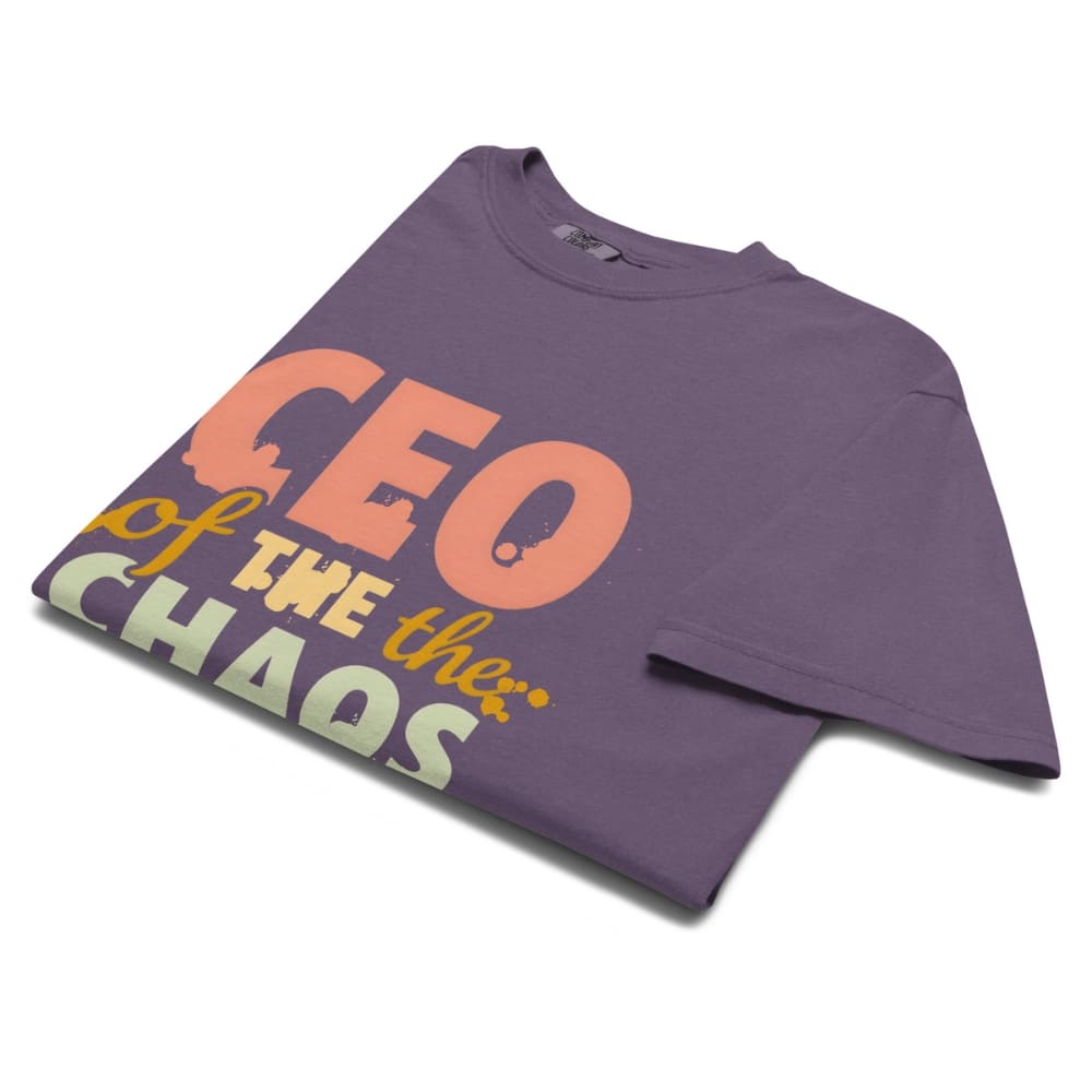 CEO of the Chaos” printed on a heavyweight cotton t-shirt in soft pastel ink, laid flat with a minimal lifestyle background.