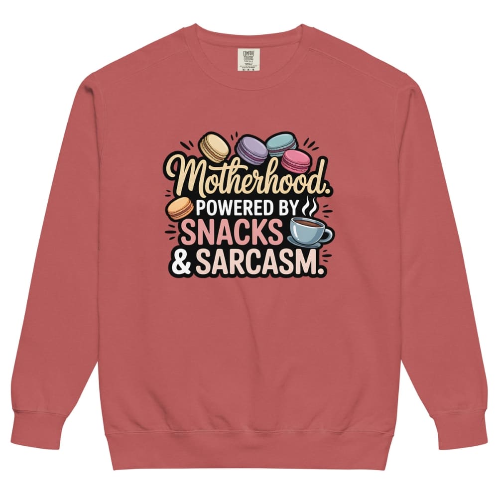 Sweatshirt design with text “Motherhood. Powered by Snacks & Sarcasm.” featuring colorful macarons and a steaming coffee cup on vintage-washed cotton fleece.