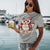 Cute cartoon owl cheerleader holding a pom-pom and clipboard, wearing a red cap with the quote “Behind Every Great Swing Is a Loud Mom” – featured on garment-dyed heavyweight cotton tee