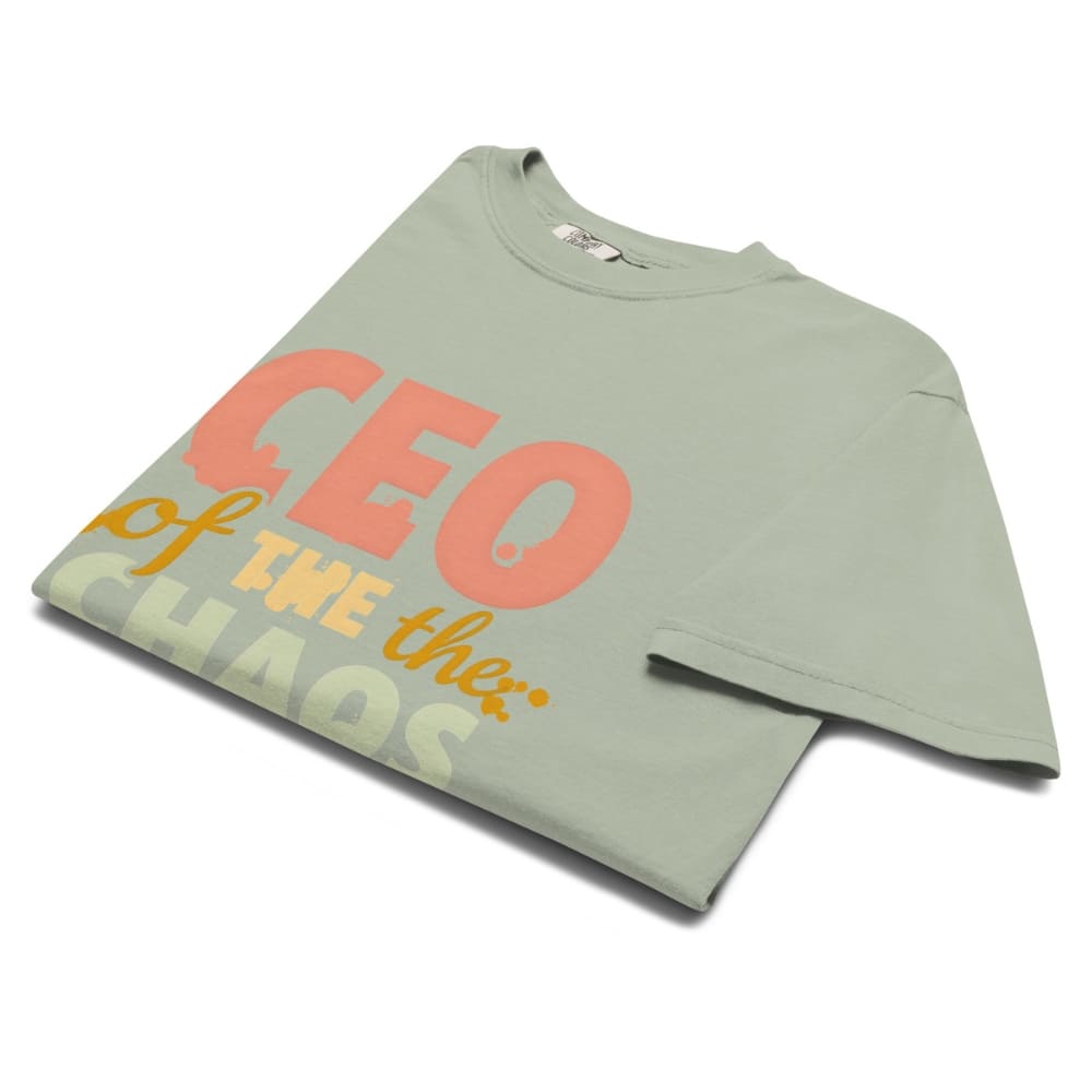 CEO of the Chaos” printed on a heavyweight cotton t-shirt in soft pastel ink, laid flat with a minimal lifestyle background.