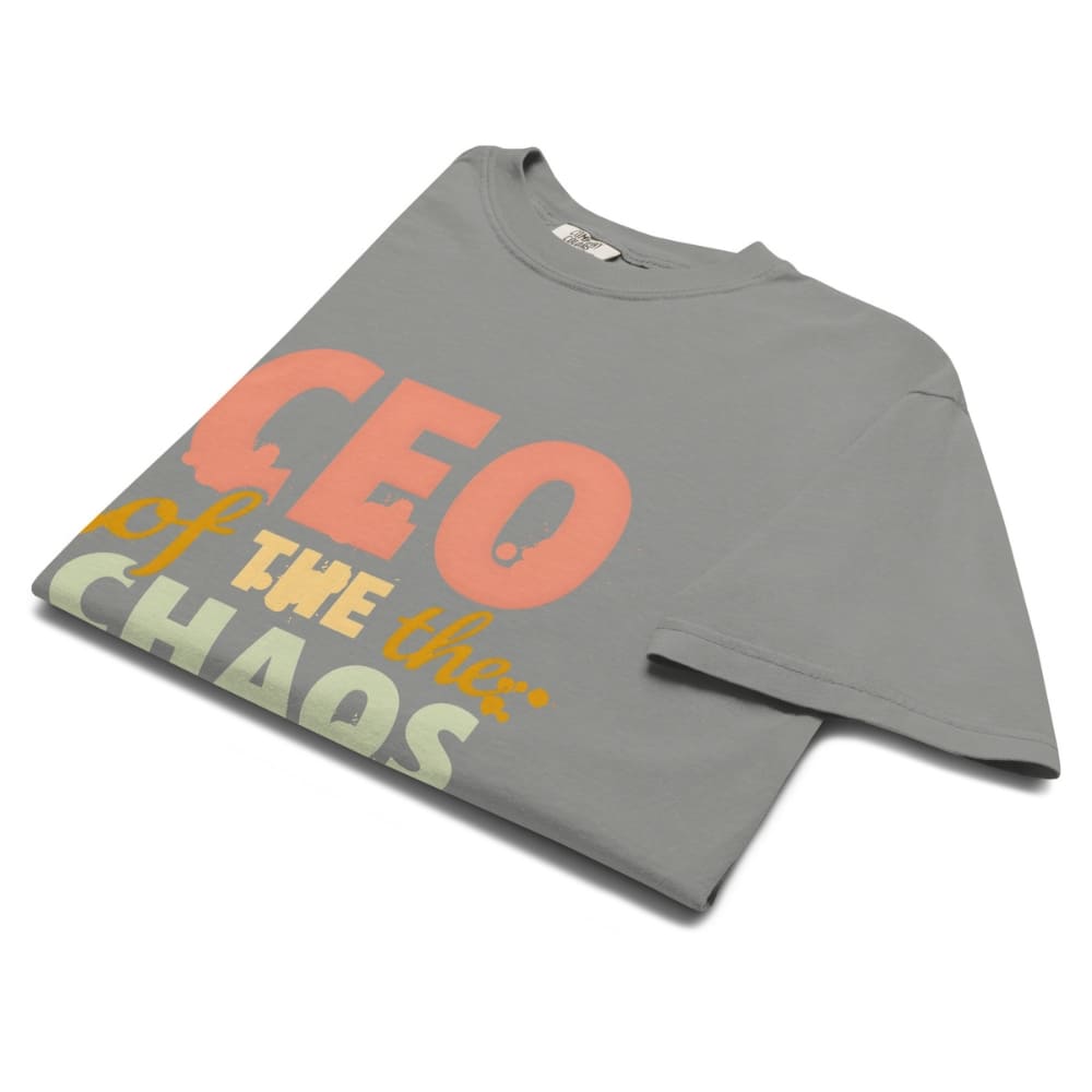 CEO of the Chaos” printed on a heavyweight cotton t-shirt in soft pastel ink, laid flat with a minimal lifestyle background.