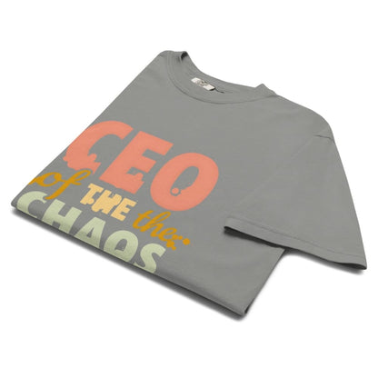 CEO of the Chaos” printed on a heavyweight cotton t-shirt in soft pastel ink, laid flat with a minimal lifestyle background.