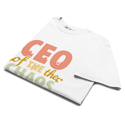 CEO of the Chaos” printed on a heavyweight cotton t-shirt in soft pastel ink, laid flat with a minimal lifestyle background.