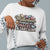 Sweatshirt design with text “Motherhood. Powered by Snacks & Sarcasm.” featuring colorful macarons and a steaming coffee cup on vintage-washed cotton fleece.