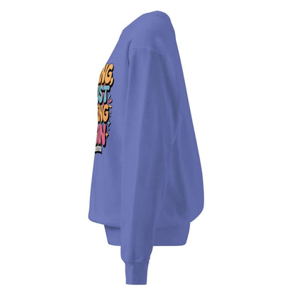 Purple sweatshirt with colorful text design on a white background