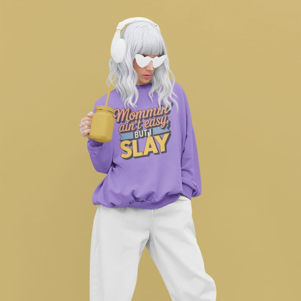 “Mommin' Ain’t Easy But I Slay” retro-style DTG printed design in peach, blue, and yellow on vintage garment-dyed fleece sweatshirt