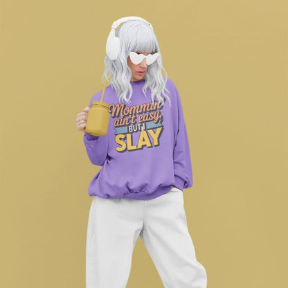 “Mommin' Ain’t Easy But I Slay” retro-style DTG printed design in peach, blue, and yellow on vintage garment-dyed fleece sweatshirt