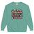 Sweatshirt design with text “Motherhood. Powered by Snacks & Sarcasm.” featuring colorful macarons and a steaming coffee cup on vintage-washed cotton fleece.