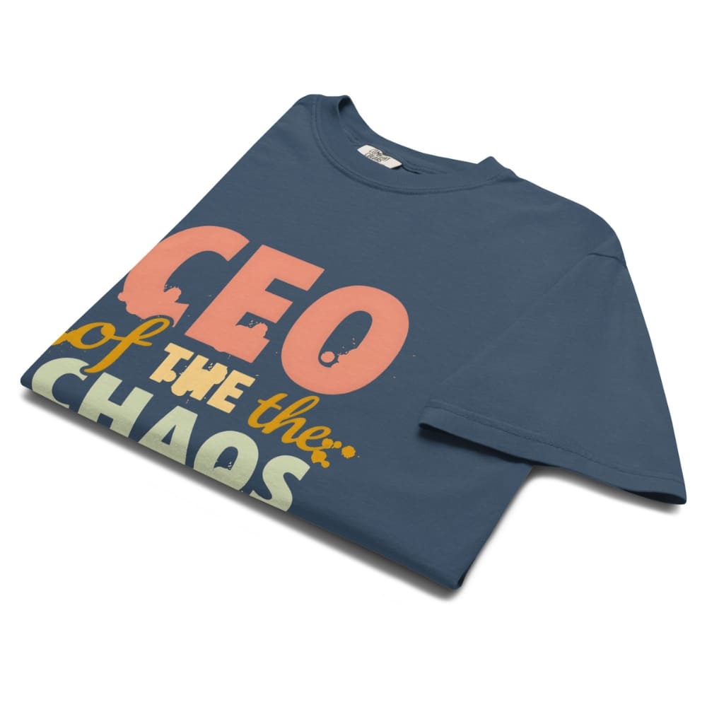 CEO of the Chaos” printed on a heavyweight cotton t-shirt in soft pastel ink, laid flat with a minimal lifestyle background.