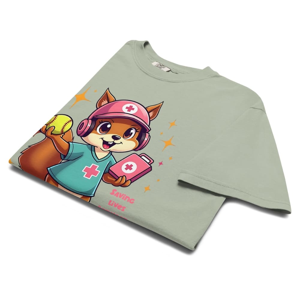 Cute squirrel nurse cartoon in scrubs, pink cap, and headset holding a softball and medical kit with the phrase “Saving Lives Between Innings” — printed on a heavyweight cotton t-shirt