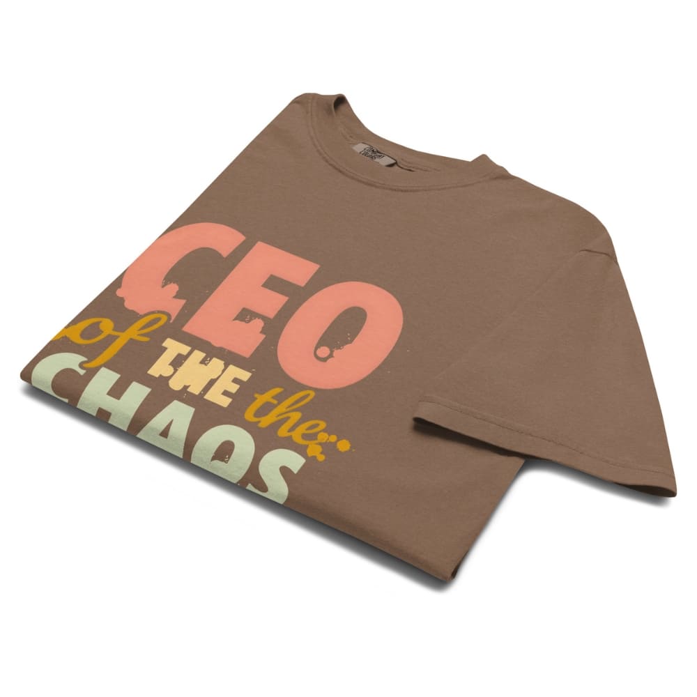 CEO of the Chaos” printed on a heavyweight cotton t-shirt in soft pastel ink, laid flat with a minimal lifestyle background.
