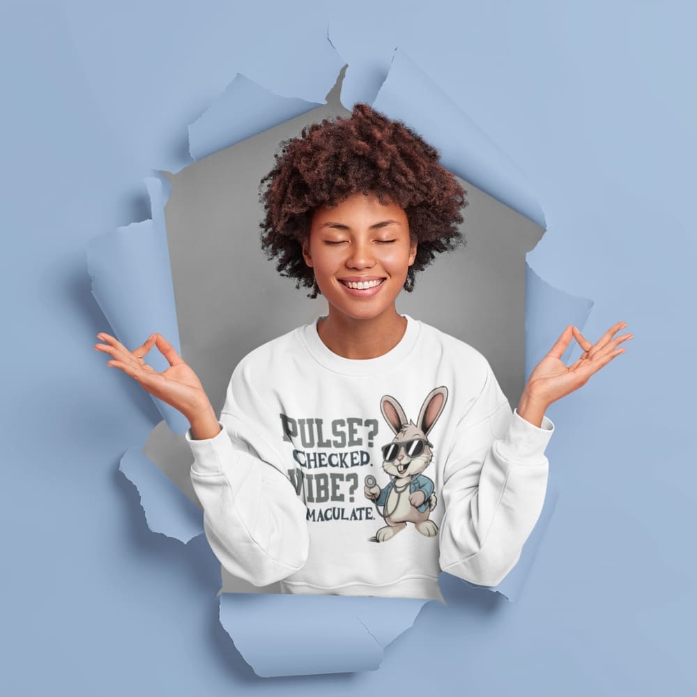 Person wearing a white sweatshirt with a graphic design on a blue background