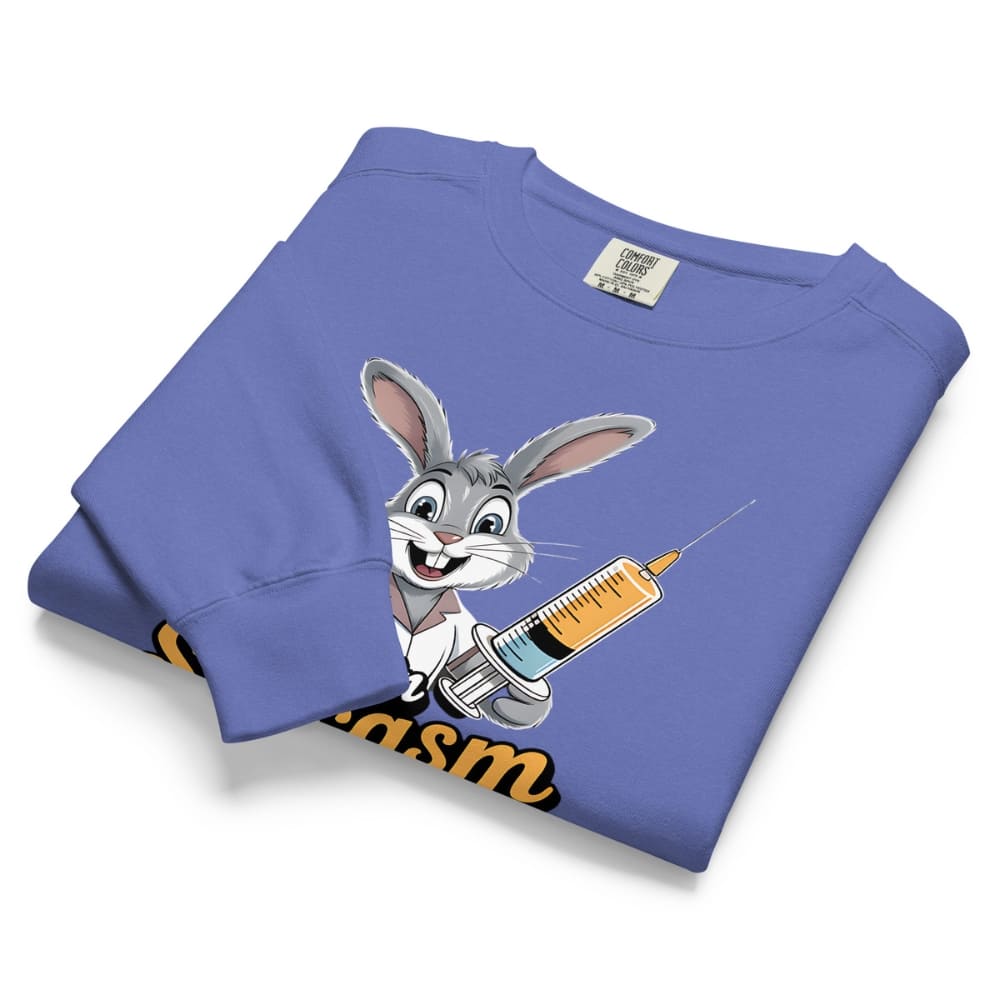 Folded blue sweatshirt with cartoon character holding a syringe on a white background