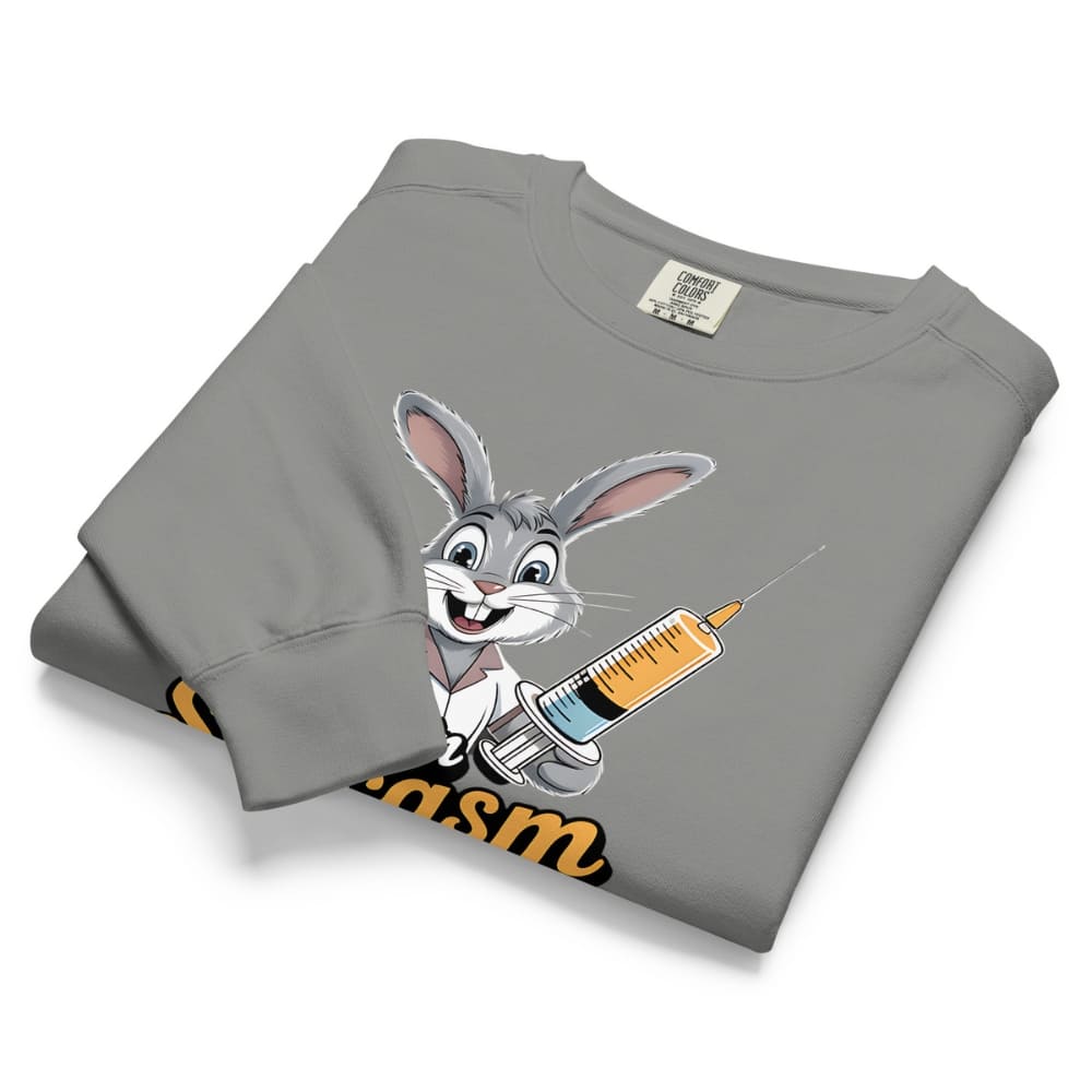 Folded gray sweatshirt with cartoon character holding a syringe on a white background