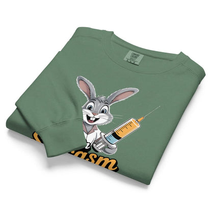 Folded green sweatshirt with cartoon character holding a syringe on a white background