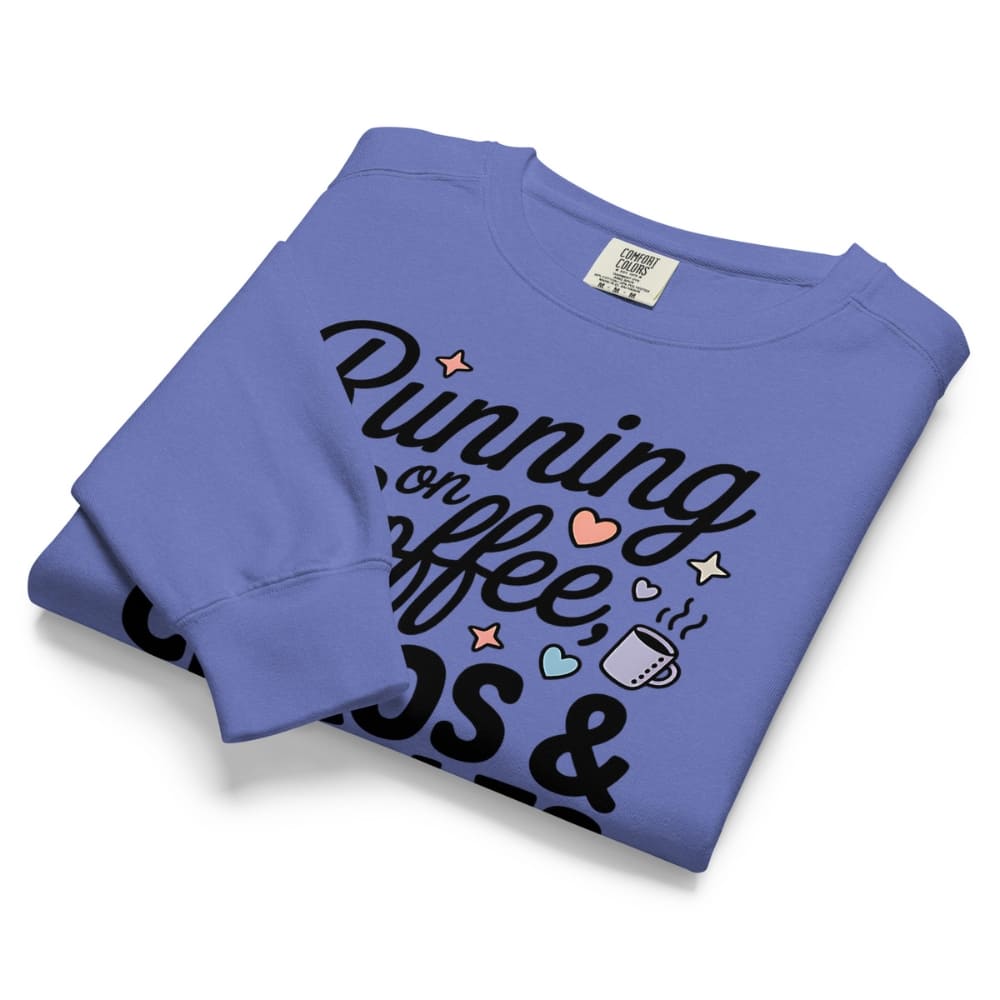 Folded blue sweatshirt with text and graphics on a white background