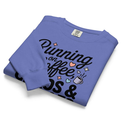 Folded blue sweatshirt with text and graphics on a white background