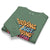 Folded green sweatshirt with colorful text design on a white background