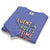 Folded blue sweatshirt with colorful text design on a white background