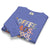 Folded blue sweatshirt with colorful text design on a white background
