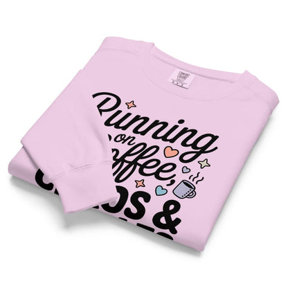 Folded pink sweatshirt with text and graphics on a white background