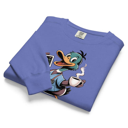 Folded blue sweatshirt with cartoon character holding a coffee cup on a white background