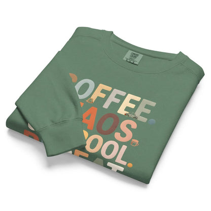 Folded green sweatshirt with colorful text on a white background