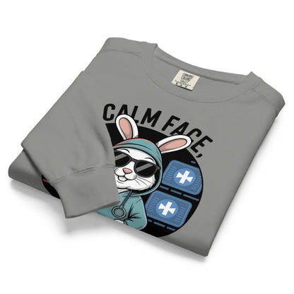 Folded gray sweatshirt with a graphic design of a rabbit wearing sunglasses and a hoodie on a white background.