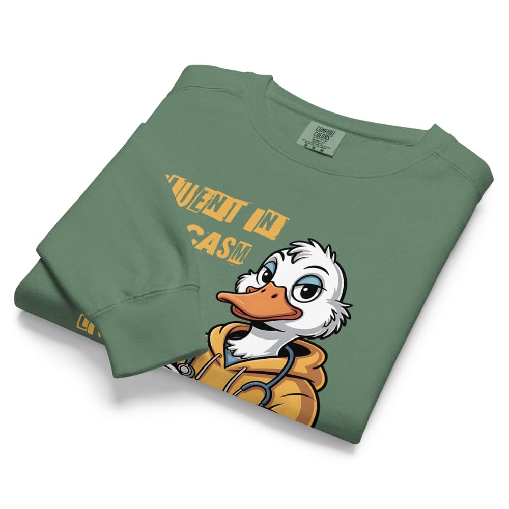 Folded green sweatshirt with cartoon duck character and text on a white background