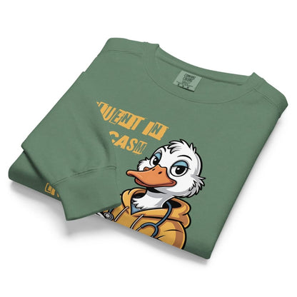 Folded green sweatshirt with cartoon duck character and text on a white background