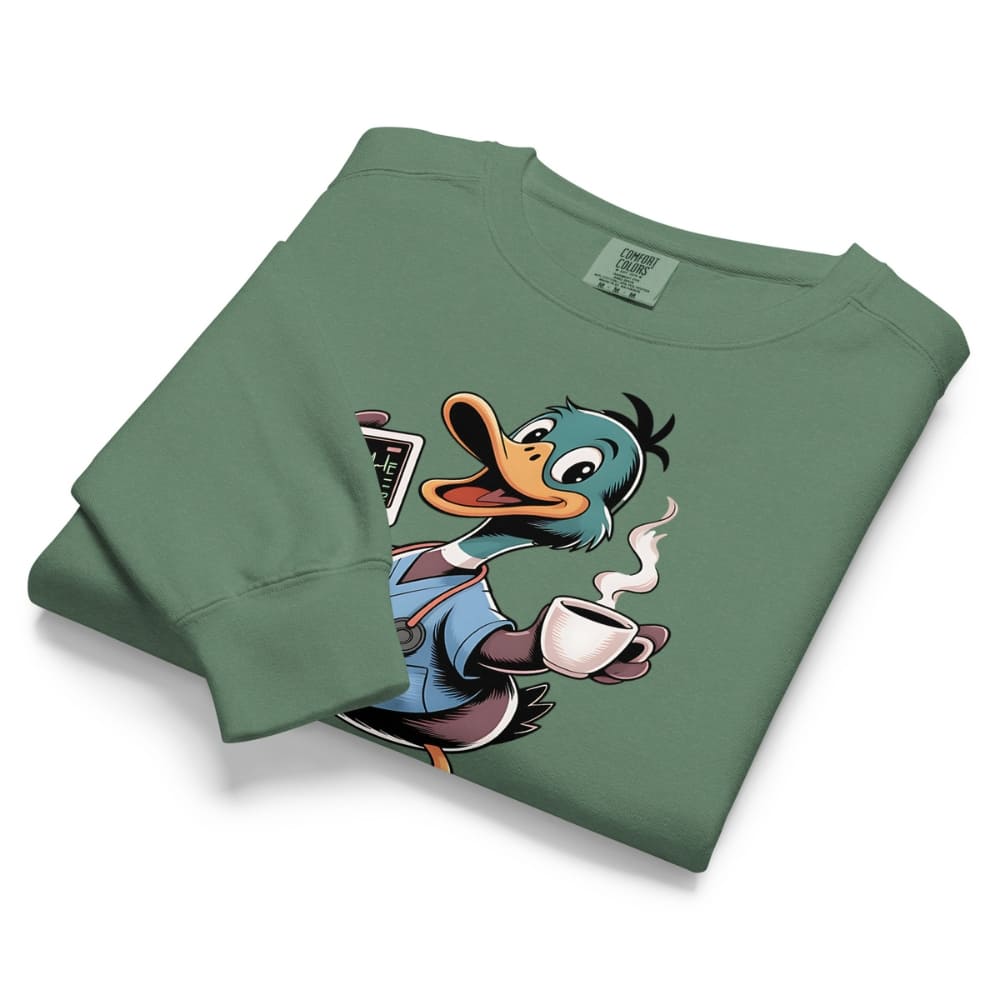 Folded green sweatshirt with cartoon duck character holding a coffee cup on a white background