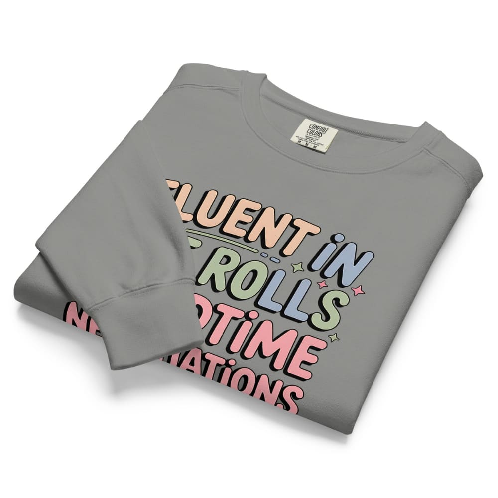 Folded gray sweatshirt with colorful text design on a white background