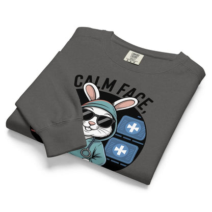 Folded gray sweatshirt with a graphic design of a rabbit and text on a white background