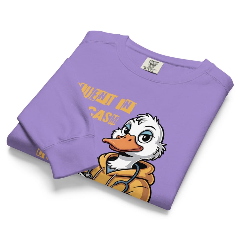 Folded purple sweatshirt with cartoon duck and text on a white background