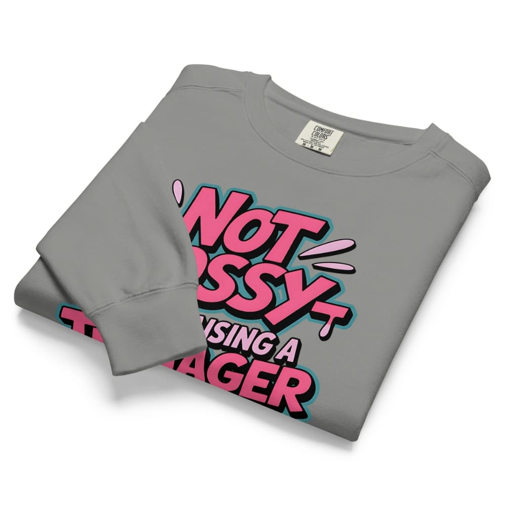 Folded gray sweatshirt with pink and black text on a white background