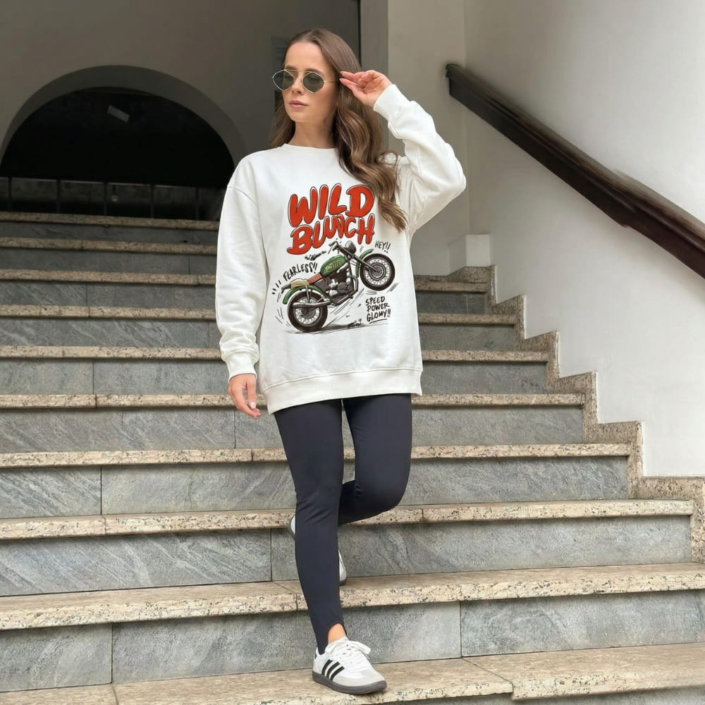 Woman wearing a 'Wild Bunch' sweatshirt on stone steps