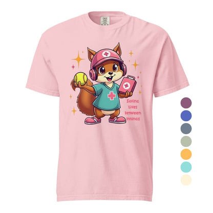 Cute squirrel nurse cartoon in scrubs, pink cap, and headset holding a softball and medical kit with the phrase “Saving Lives Between Innings” — printed on a heavyweight cotton t-shirt