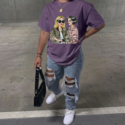 Person wearing a purple t-shirt with graphic design, holding a black handbag on a concrete floor.