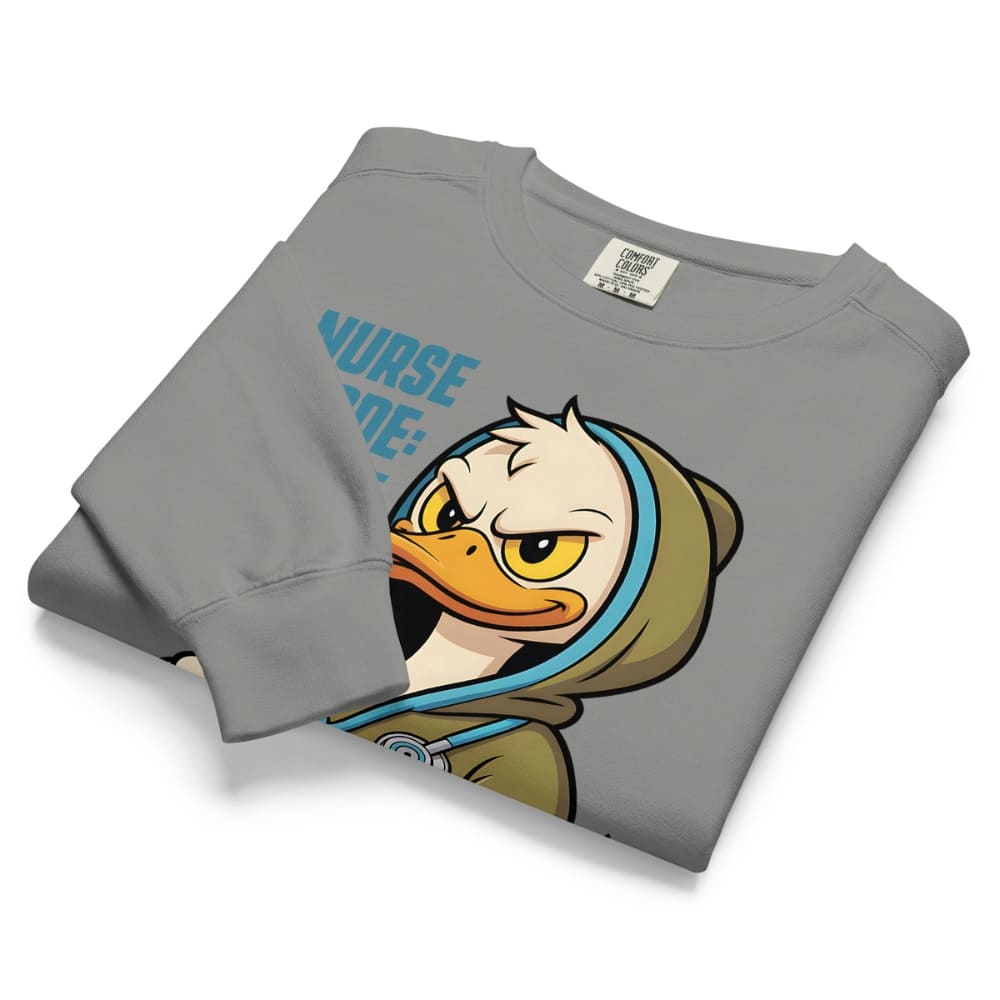Folded gray sweatshirt with cartoon duck design and 'Nurse' text on a white background