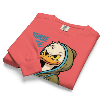 Folded pink sweatshirt with cartoon duck design and 'NURSE' text on a white background