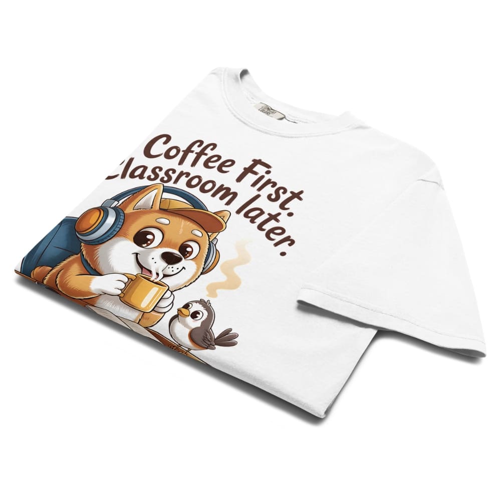 White t-shirt with cartoon dog and text 'Coffee First, Classroom Later' on a white background