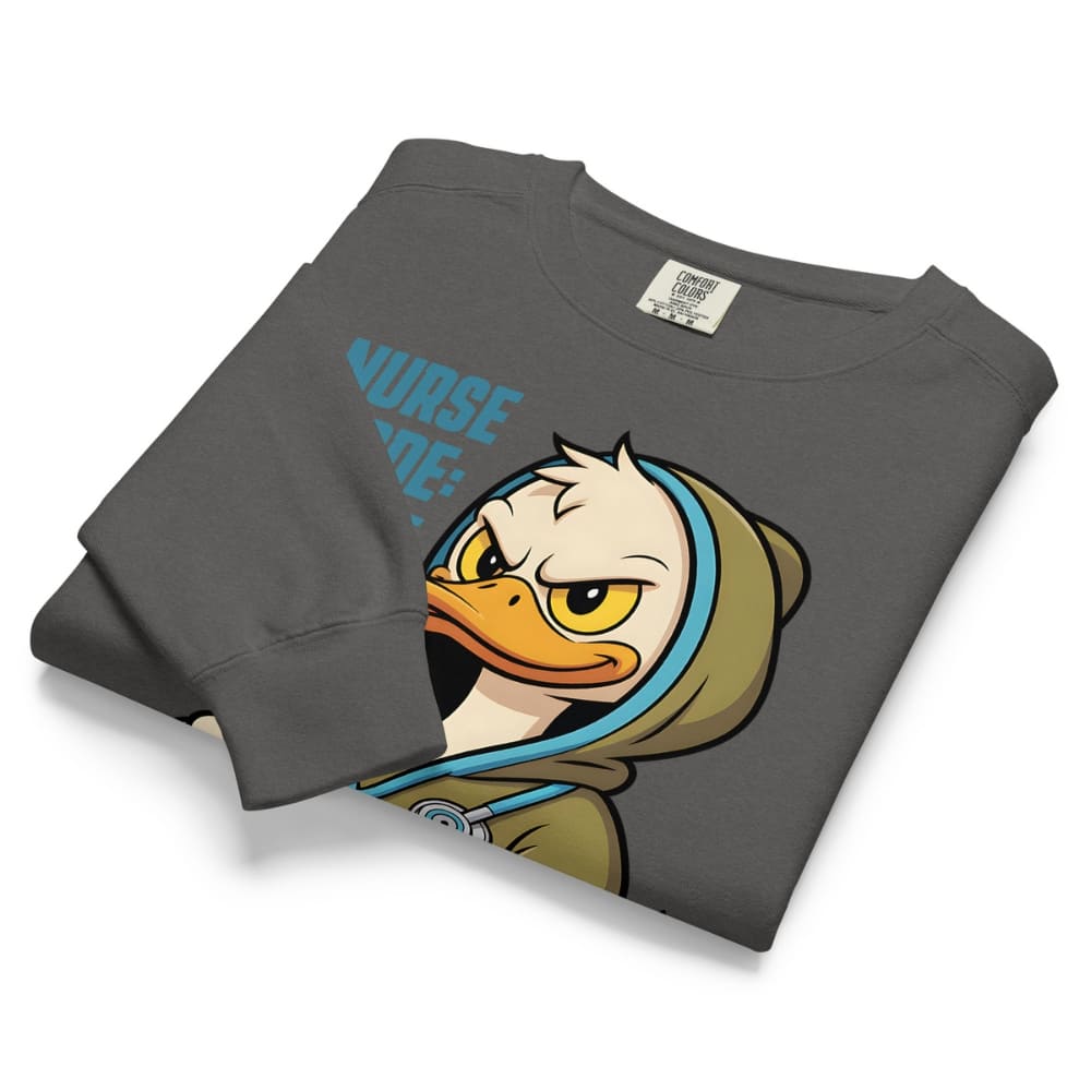 Folded gray sweatshirt with cartoon duck design and 'Nurse' text on a white background